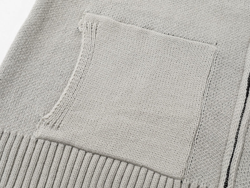 Close-up of light gray front patch pocket on the knit cardigan