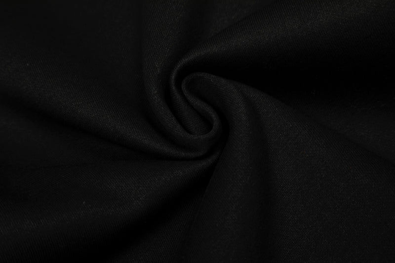 Close-up of black sweatshirt fabric folds and soft knit texture