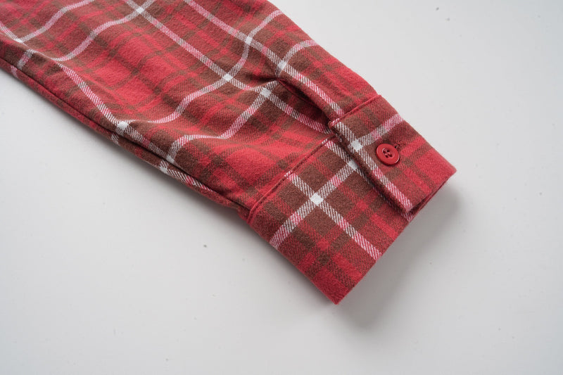 Cuffed red plaid flannel sleeve with button detail