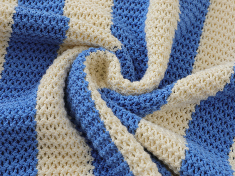 Close-up of twisted blue and cream open-weave knit fabric and V-neck collar