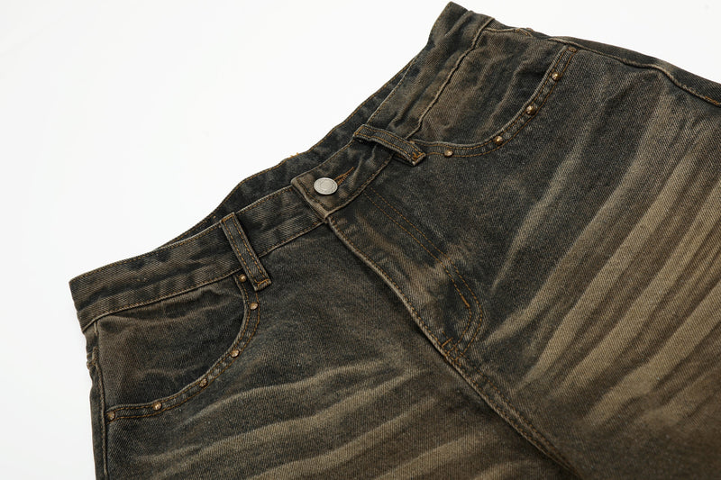 Close-up of jeans waistband, belt loops, button closure, and faded denim texture