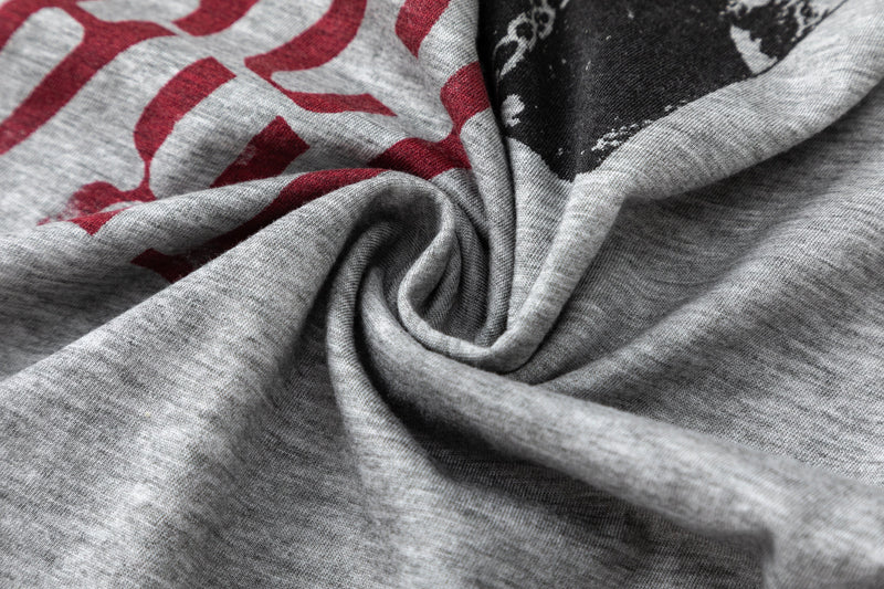 Close-up of gray tee fabric with printed red and black graphic detail