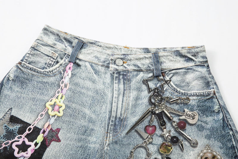Upper front of acid wash denim shorts with front pockets, button fly, and hanging charms