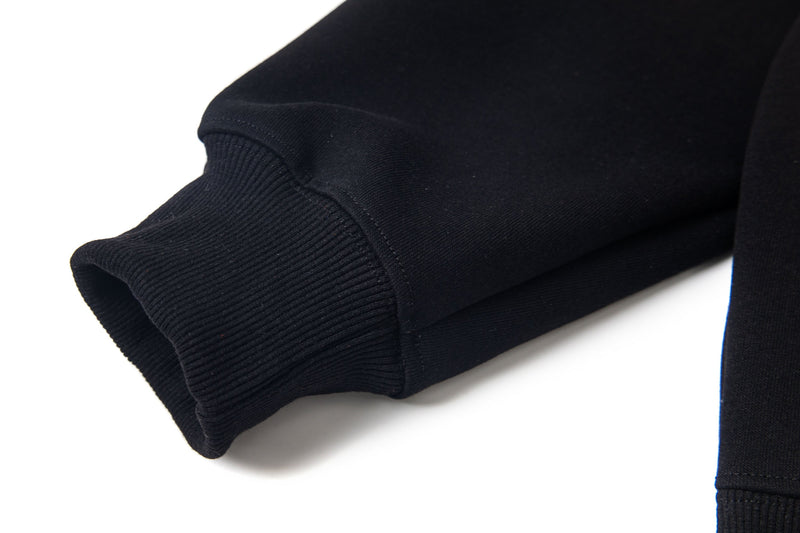 Black hoodie sleeve cuff close-up with ribbed knit hem