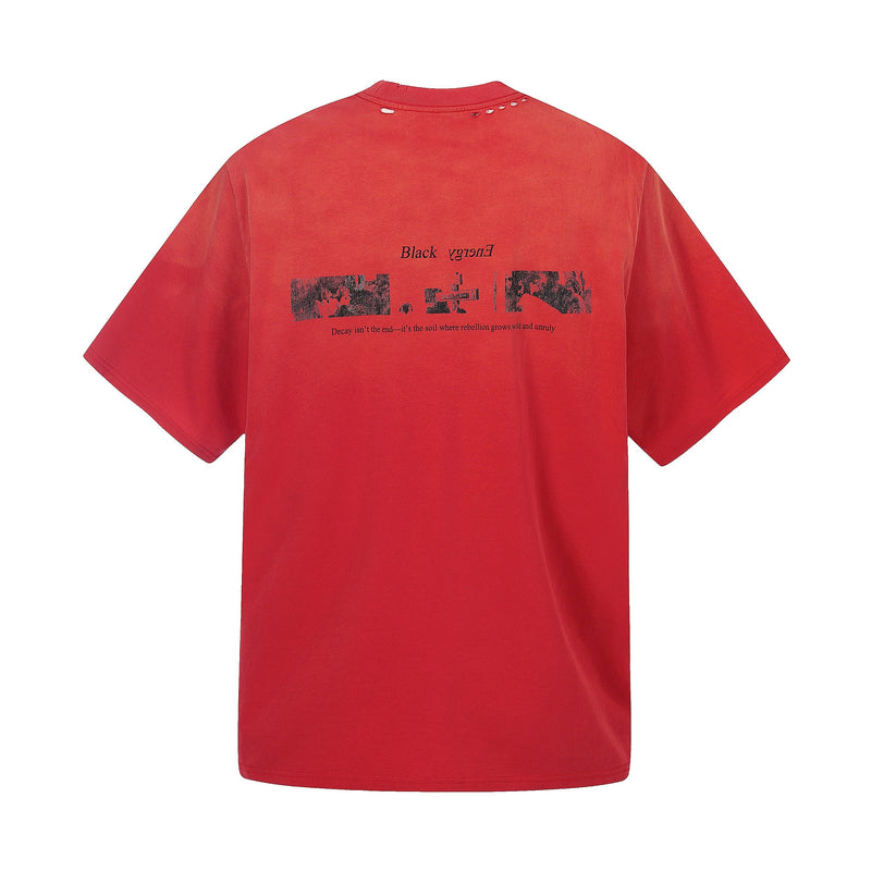 Red distressed graphic T-shirt with black text and abstract print, featuring a relaxed streetwear fit on a white background