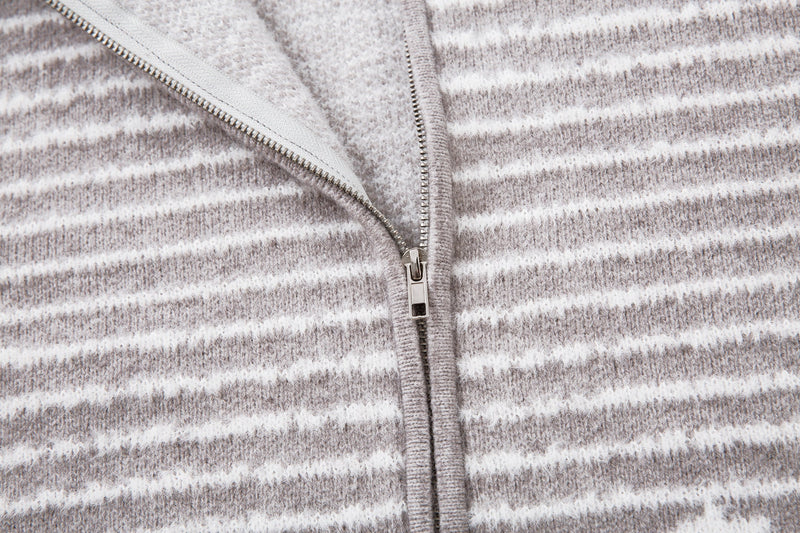 Close-up of the jacket front zipper on gray striped knit fabric