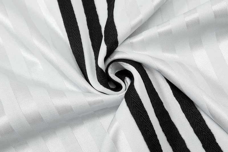 White football jersey fabric with bold black script stripes, shown in a close-up swirl of textured material