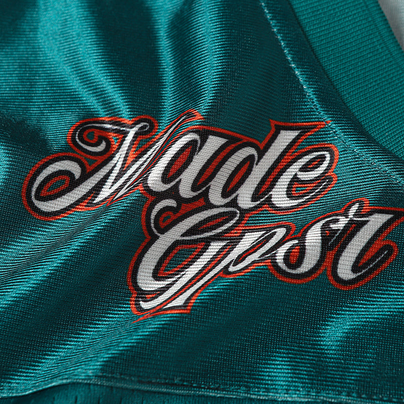 Teal crack number football jersey with bold Made Grit graphic and textured athletic fabric