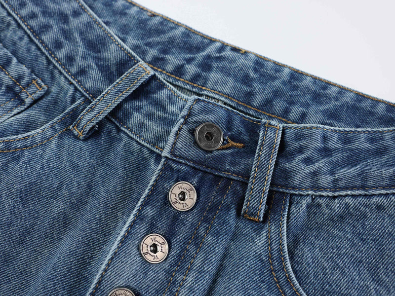 Close-up of blue denim waistband and front button fly
