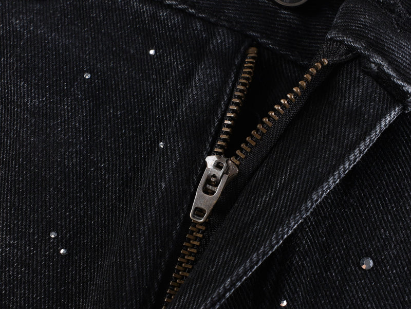 Black zipper fly close-up with rhinestone-speckled denim