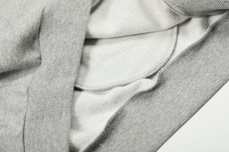 Close-up of light gray hoodie interior and seam details