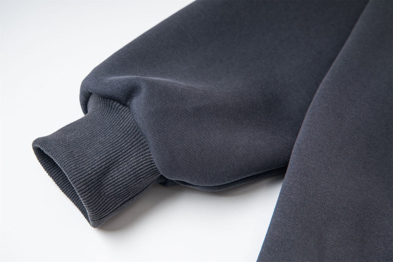 Close-up of ribbed sleeve cuff on dark zip hoodie