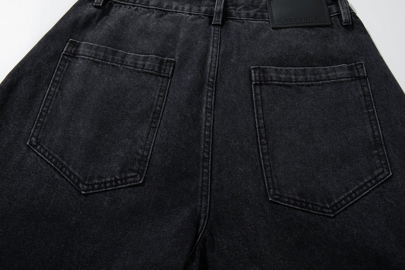 Back pocket detail on washed charcoal denim pants with paneled seams