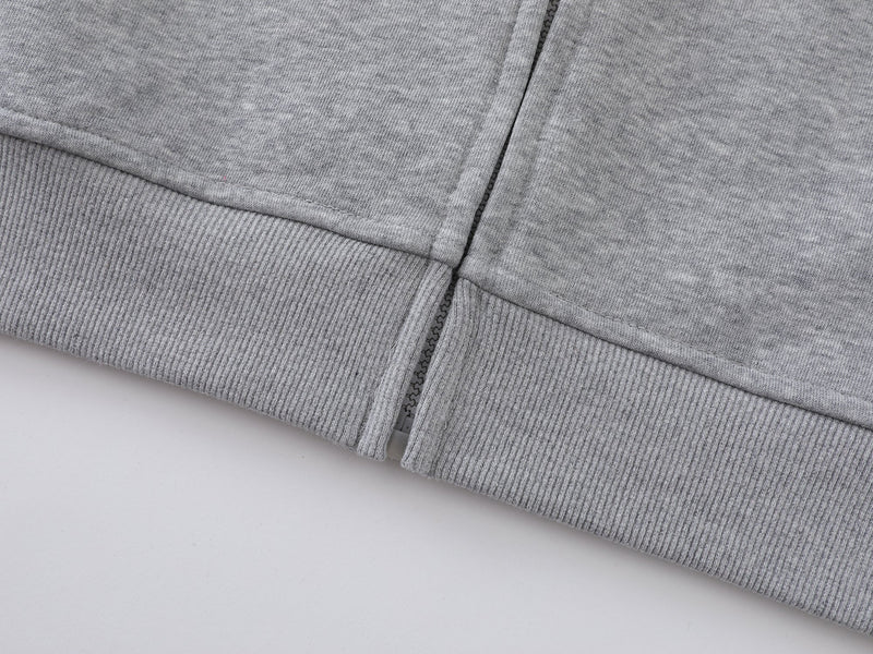 Close-up of gray hoodie ribbed hem and front zipper edge