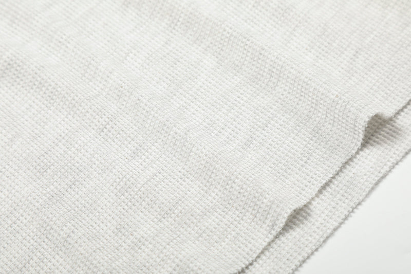 Close-up of light gray waffle knit fabric texture