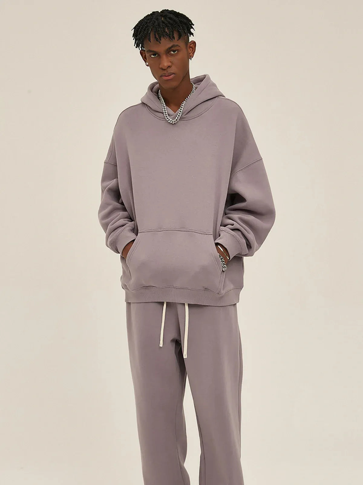 Someone stands against a plain background wearing the Custom Anime Character Dusty Lavender Hoodie—Personalized 350GSM 100% Cotton Pullover—with hands tucked in the pocket.
