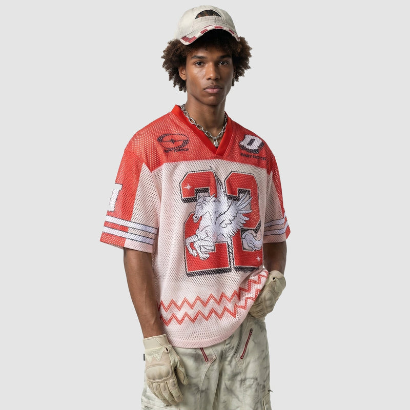 Model wearing a red and white mesh jersey T-shirt with a large 22 graphic, paired with gloves and cargo pants