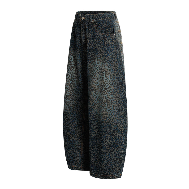 Leopard print barrel-leg jeans in dark blue denim, angled front view