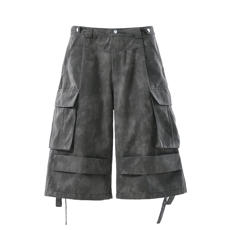 Front view of black mesh cargo shorts with snap waistband and side flap pockets