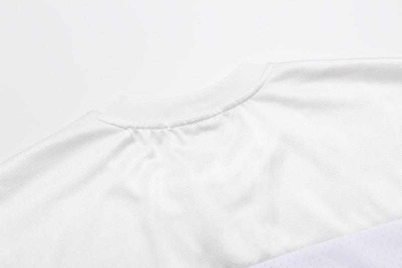 White close-up of a varsity football jersey T-shirt collar with ribbed fabric and clean streetwear styling