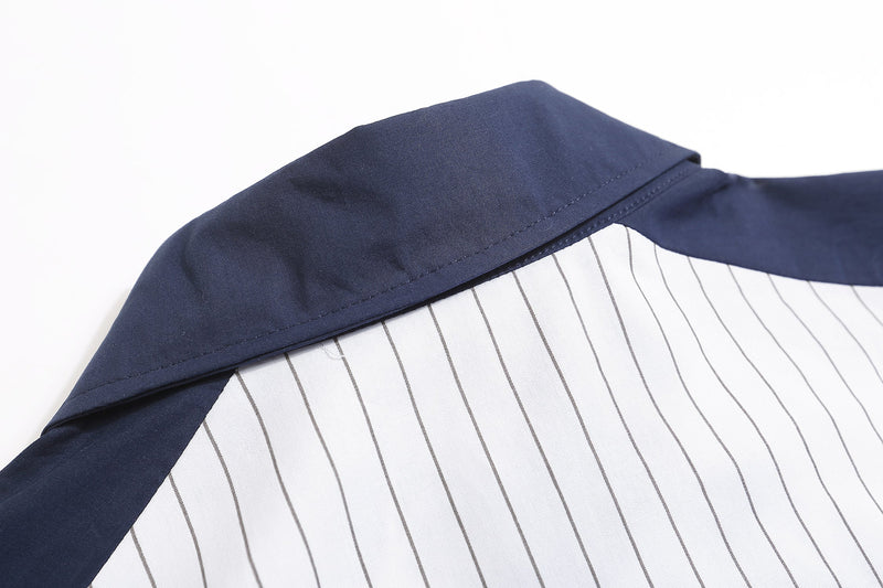 Close-up of navy collar and shoulder panel on a white pinstripe baseball shirt