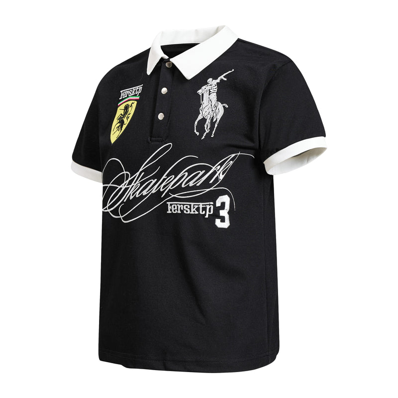 Black polo shirt with white collar and sleeve trim, featuring bold skateboard-inspired crest and graphic embroidery