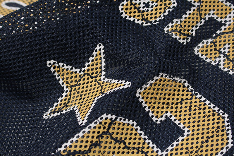 Close-up of navy mesh jersey fabric with gold star and number prints in a streetwear football style