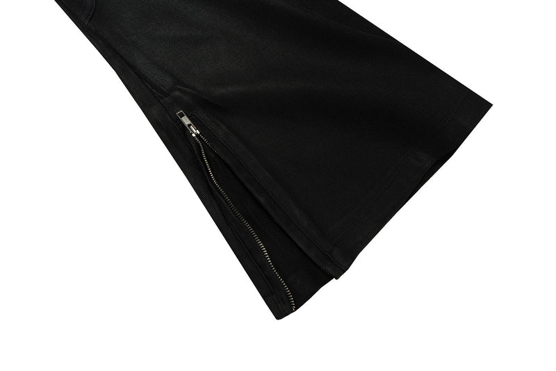 Close-up of black pant leg hem with side zipper opening