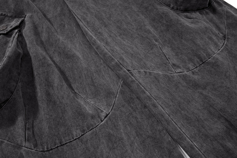 Close-up of front leg panel and seam detail on washed black cargo pants
