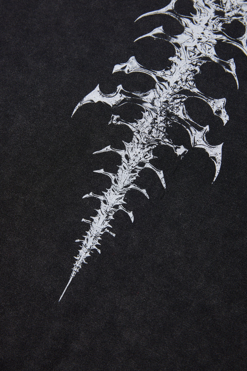 Black washed T-shirt with a white spine-inspired graphic print on the back in edgy streetwear style