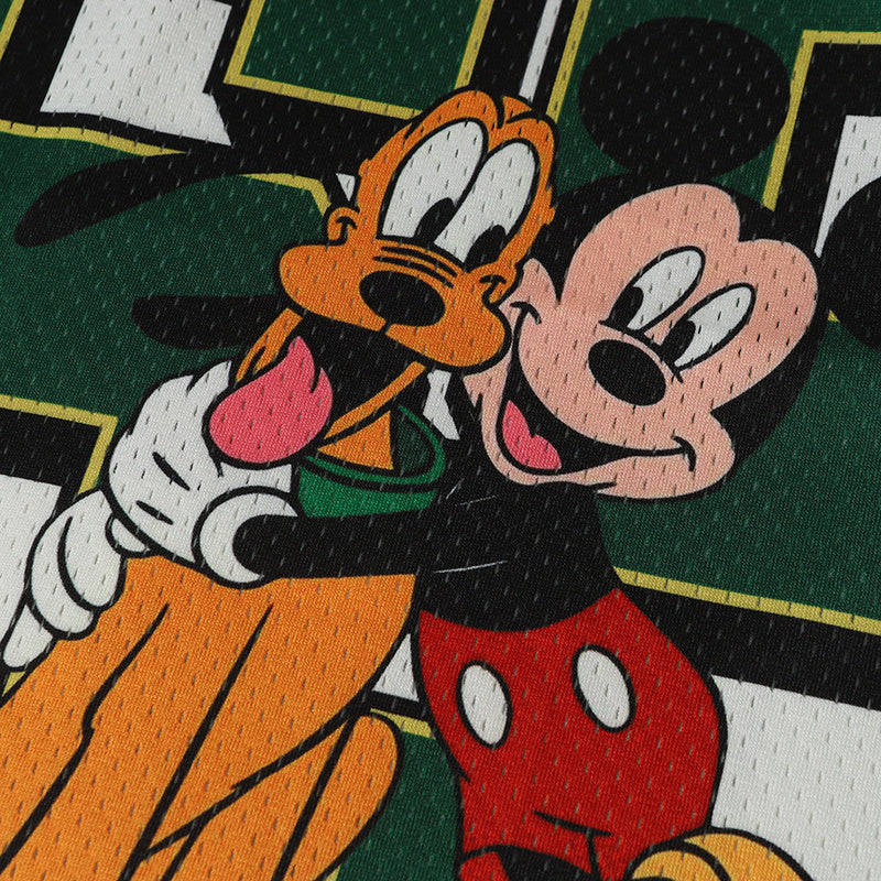 Mickey Mouse and Pluto cartoon graphic on a green varsity football jersey with bold streetwear styling