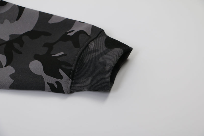 Close-up of gray ribbed sleeve cuff on black and gray camo hoodie