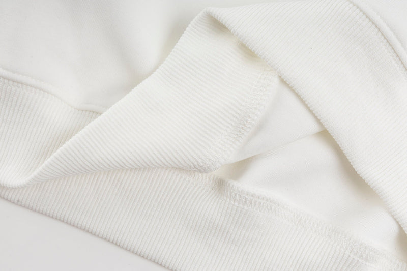 Close-up of white hoodie cuff and folded sleeve seam detail