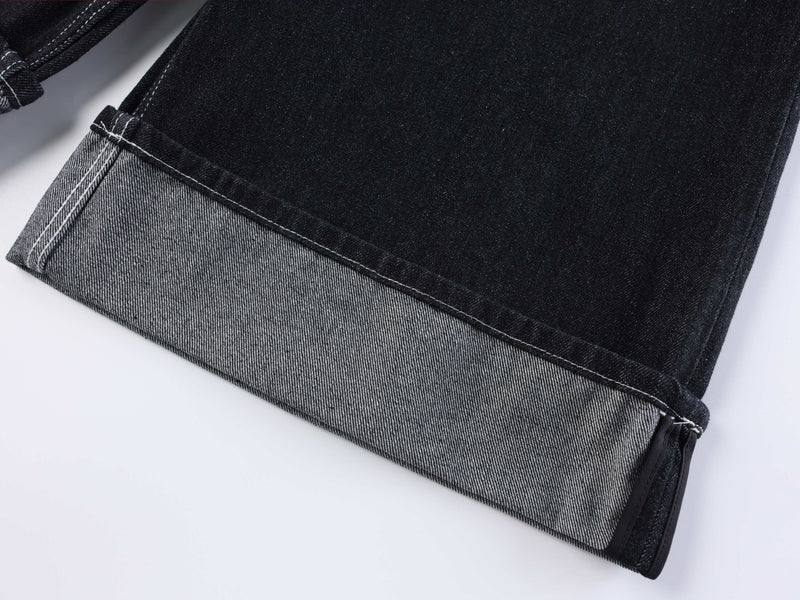 Bottom hem of dark wash denim shorts with a light folded cuff