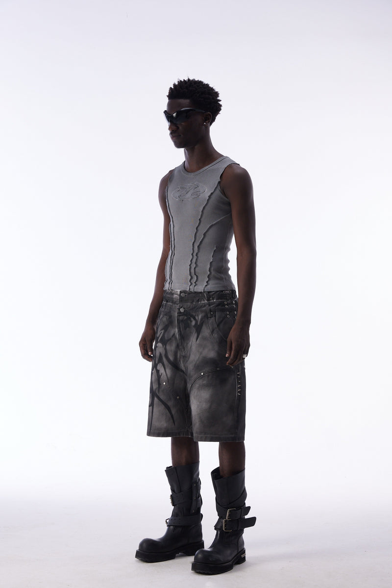Side view of model wearing gray tribal jorts and black boots