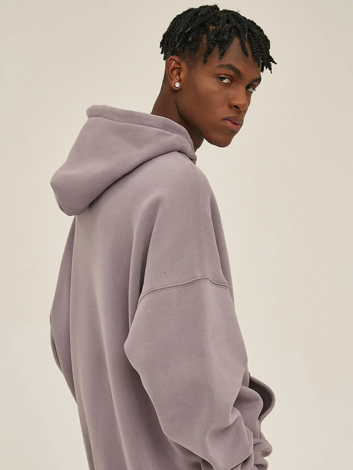 A person in a Custom Anime Character Dusty Lavender Hoodie—Personalized 350GSM 100% Cotton Pullover—faces sideways against a plain background, looking over their shoulder and highlighting its relaxed, stylish fit.
