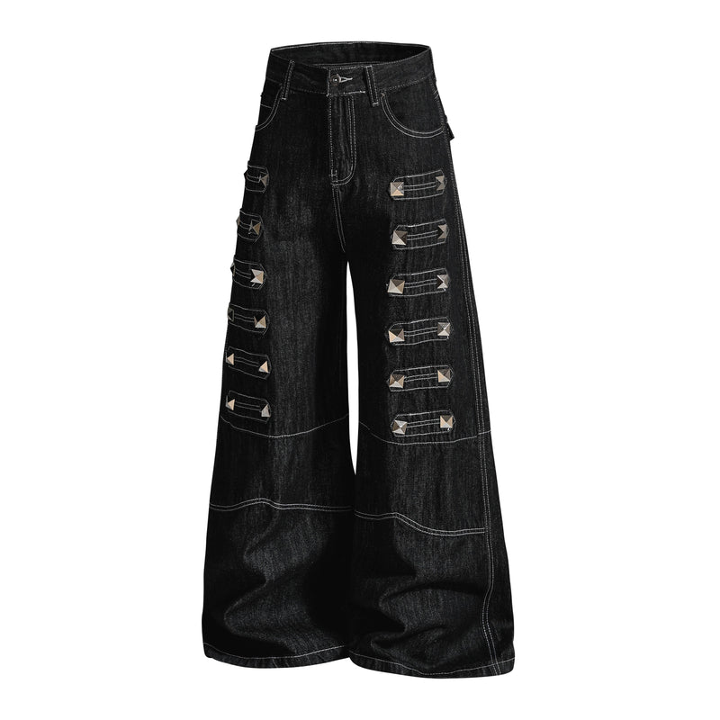 Black wide-leg denim pants with studded strap accents, angled front view