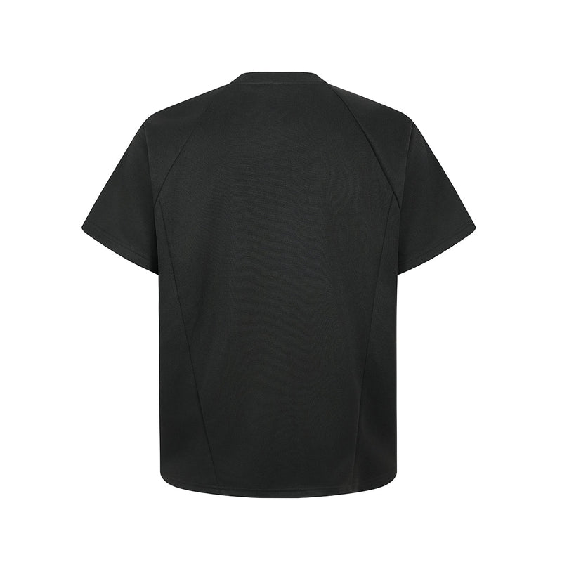 Black oversized structured tee with geometric seam detailing and short sleeves, shown flat against a white background