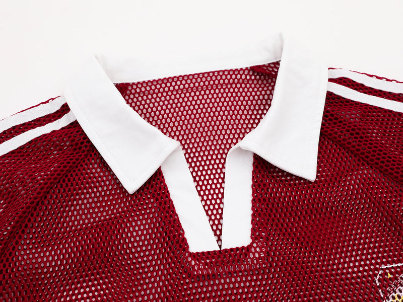 Red vintage mesh polo tee with white collar and striped shoulder details, featuring a retro athletic streetwear look