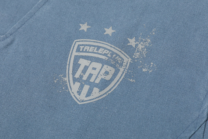 Close-up of blue sweatshirt chest graphic with shield logo and stars