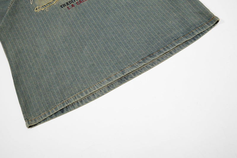 Vintage pinstripe denim sport tee with embroidered logo and stitched hem on a clean white background