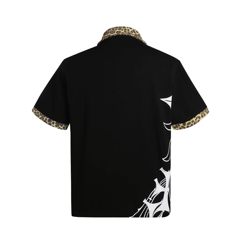 Black oversized polo shirt with leopard-print collar and cuffs, featuring gothic white graphic accents on the back and hem