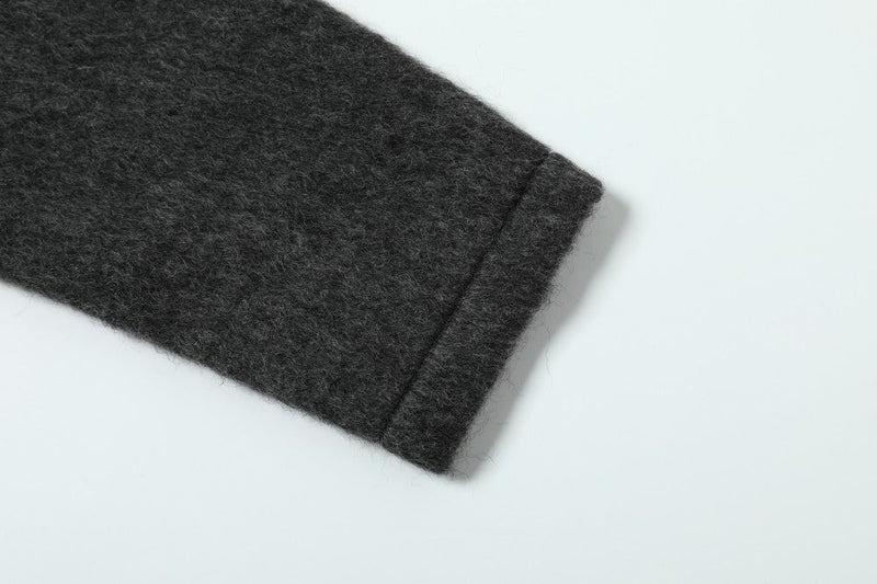 Close-up of the jacket sleeve cuff showing the soft wool-blend texture and stitched hem