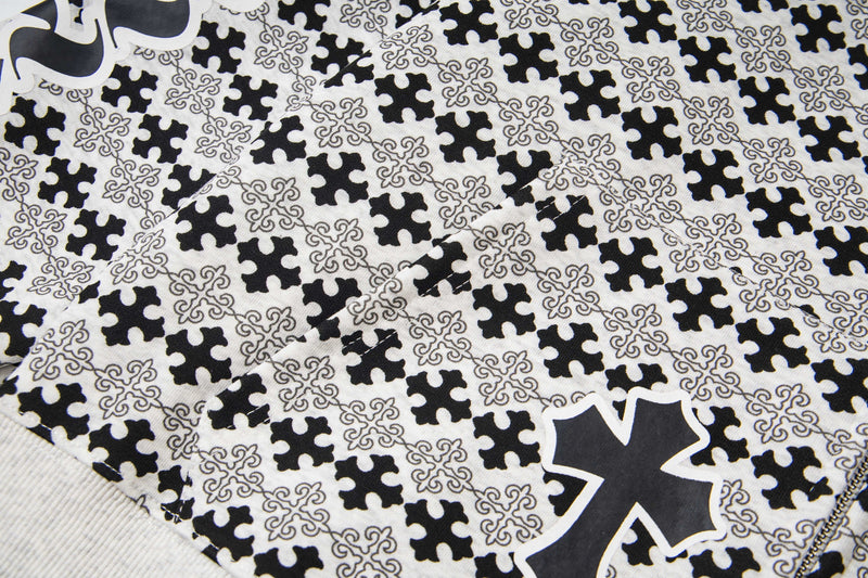 Close-up of patterned hoodie chest with black cross graphic