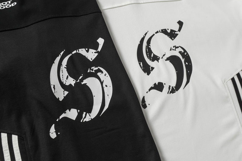 Black and white split stripe oversized V-neck street tee with bold distressed graphic print