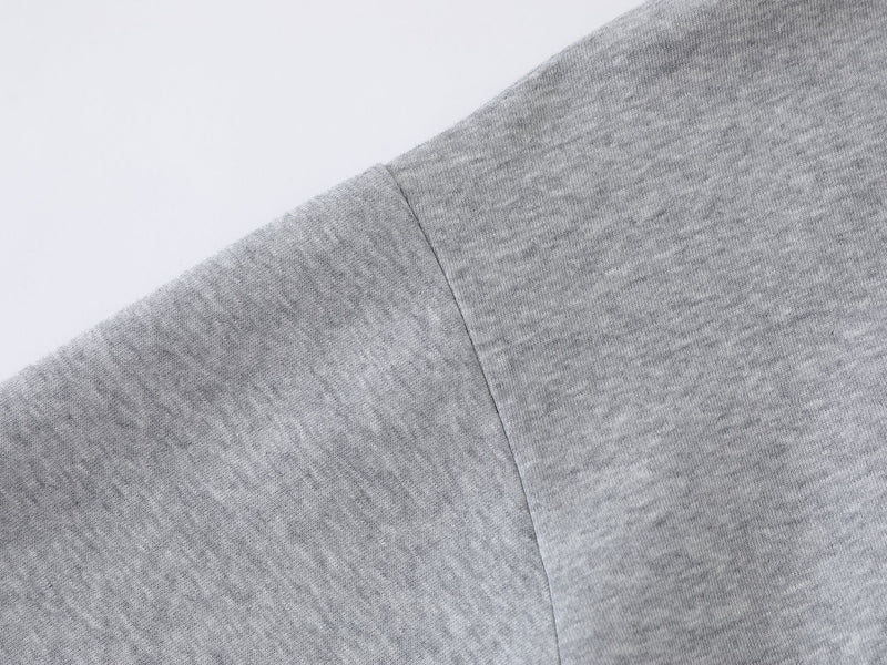 Close-up of heather gray hoodie sleeve and shoulder seam