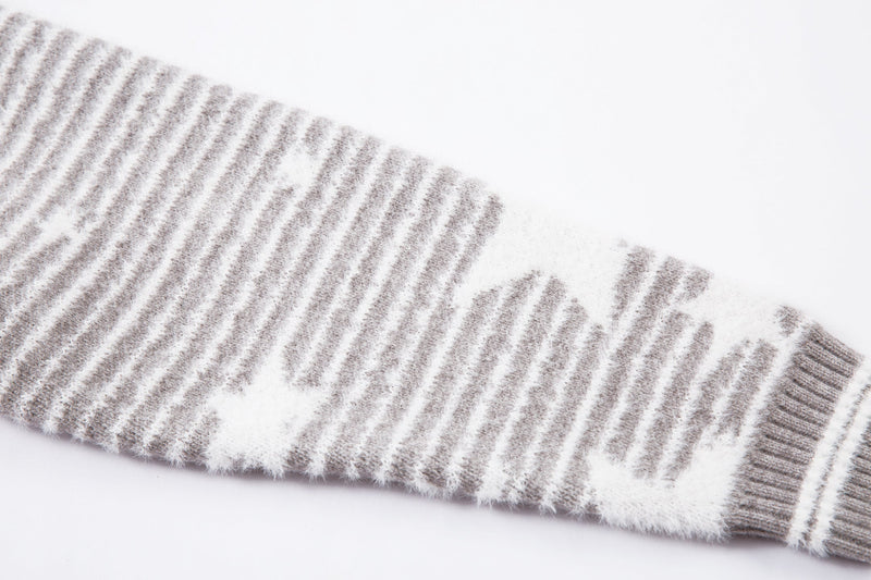 Close-up of the sleeve cuff on gray striped knit jacket