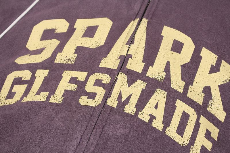 Close-up of the front lettering and zipper on purple suede zip hoodie