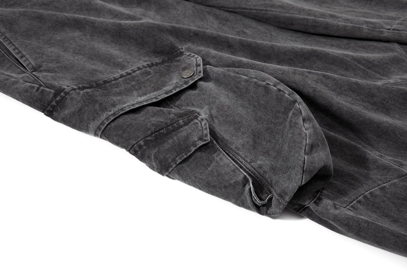 Close-up of lower leg cargo pocket and snap flap on washed black pants