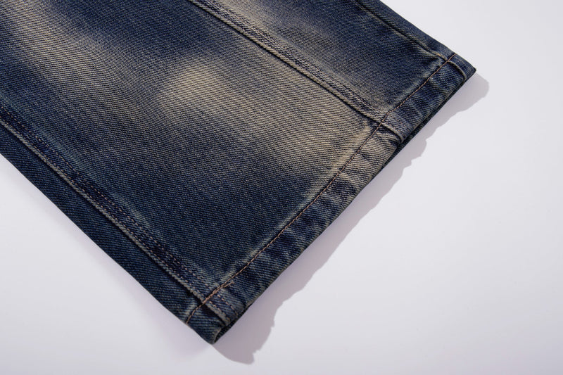 Close-up of lower leg hem on vintage blue denim jeans with faded wash